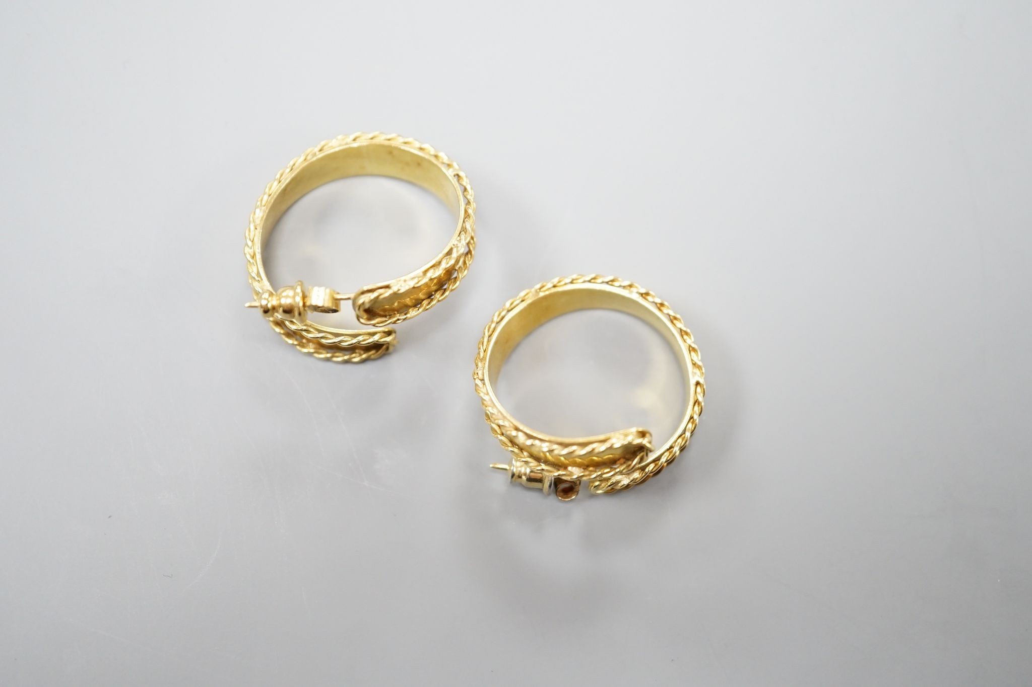 A pair of modern 18ct gold hoop earrings, with decorated borders, 27mm